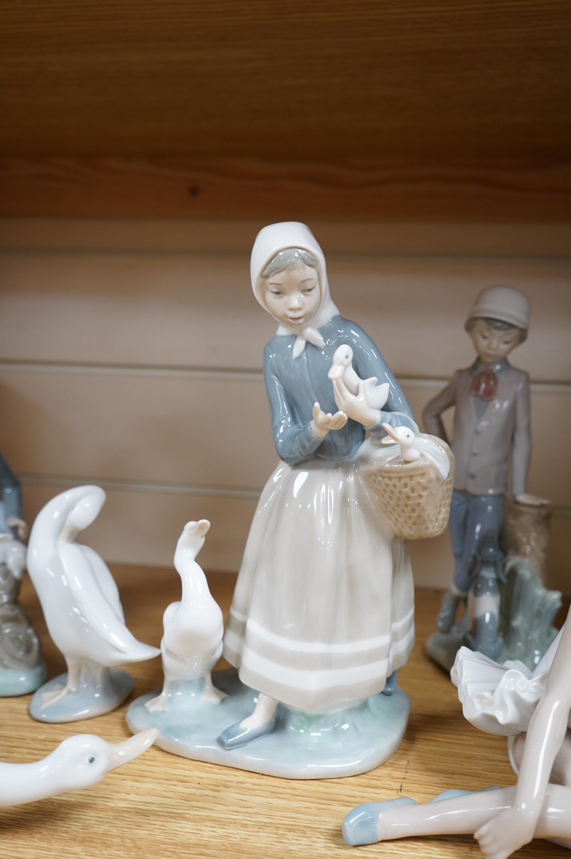 A Royal Doulton figure ‘Promenade’ HN3072, and a group of eight Lladro/Nao figures, largest 33cm high. Condition - good